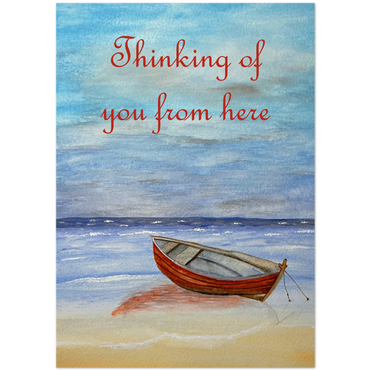 A square art print or card featuring a watercolor beach scene with a small red boat on pale sand and blue water under a blue sky. Red script text at the top reads, 'Thinking of you from here.