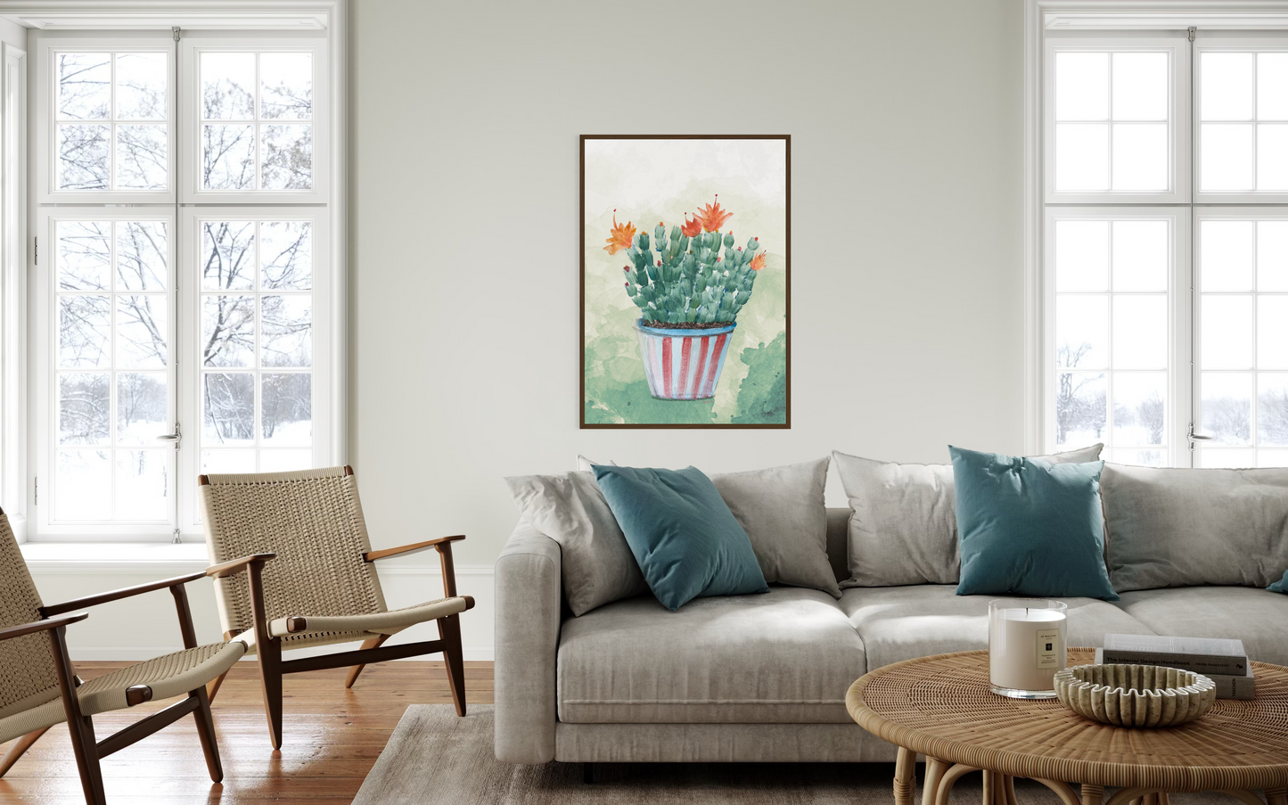 Living room with a gray sofa, armchairs, and a cactus painting on the wall.