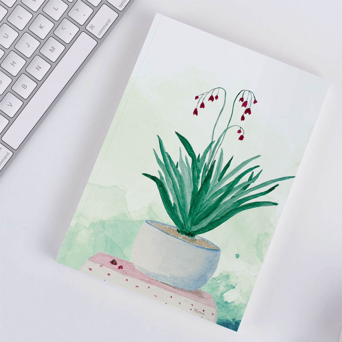 Softback Notebook A5 Plain Paper - Delicate watercolour painting of flowering plant in grey pot with deep burgundy blooms and green leaves on cream background