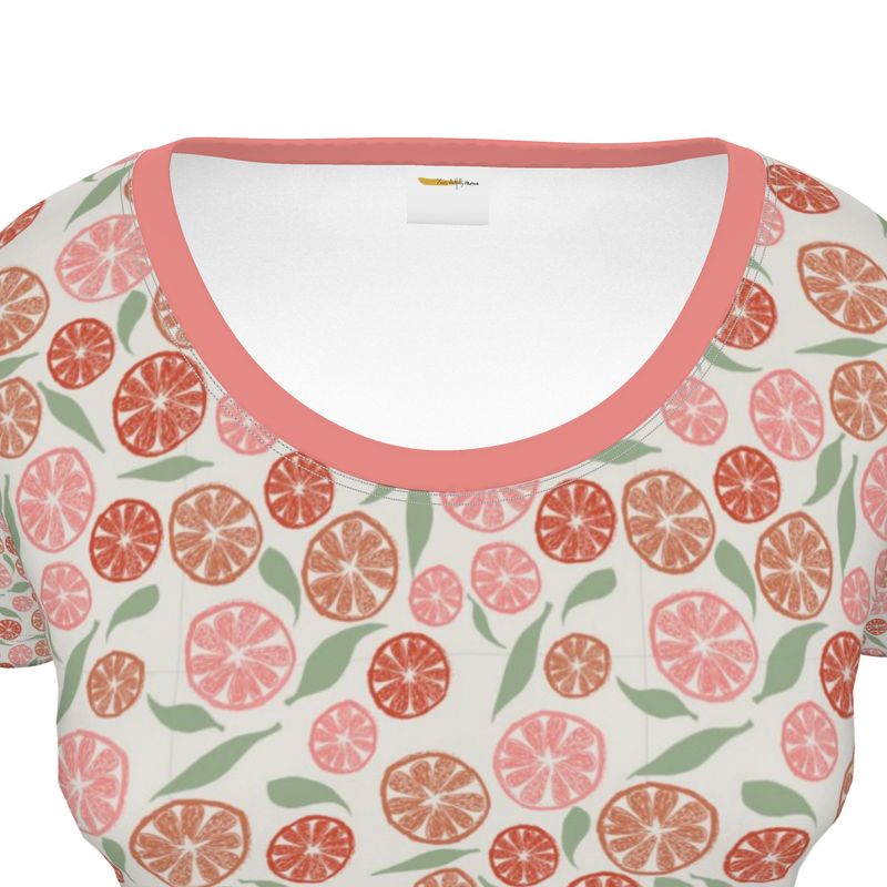 White top with pink and green citrus pattern on a white background