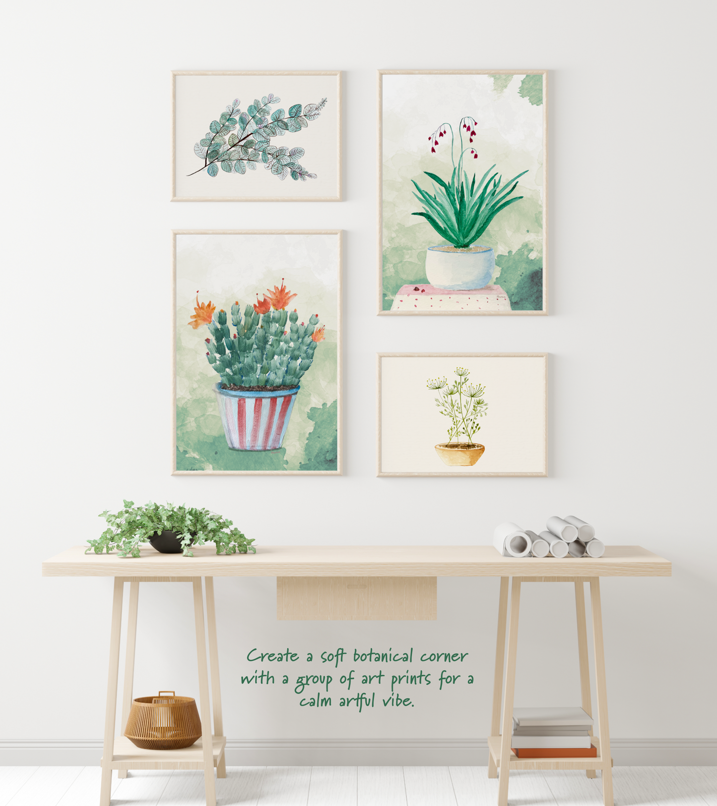 Four framed botanical prints on a wall above a wooden table.