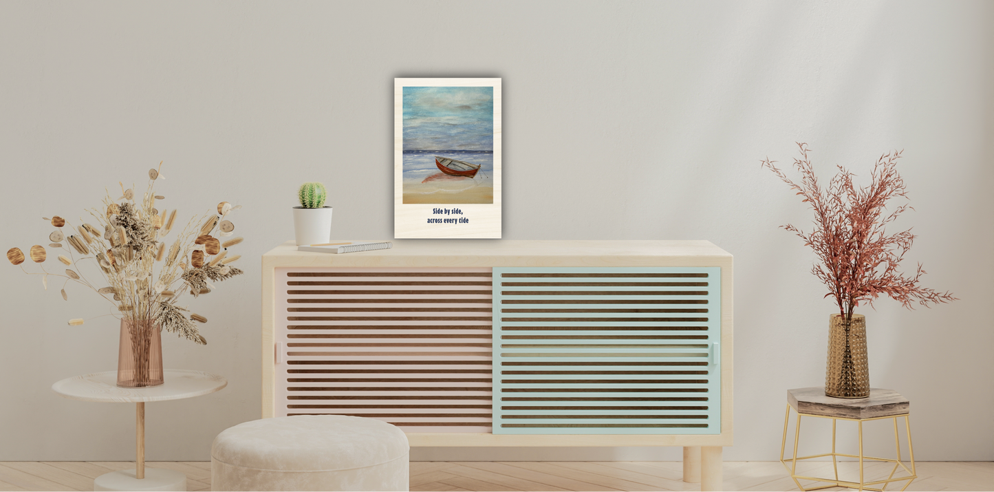 A framed art print featuring a serene beach scene with a small boat and the text 'How to live. how to die.