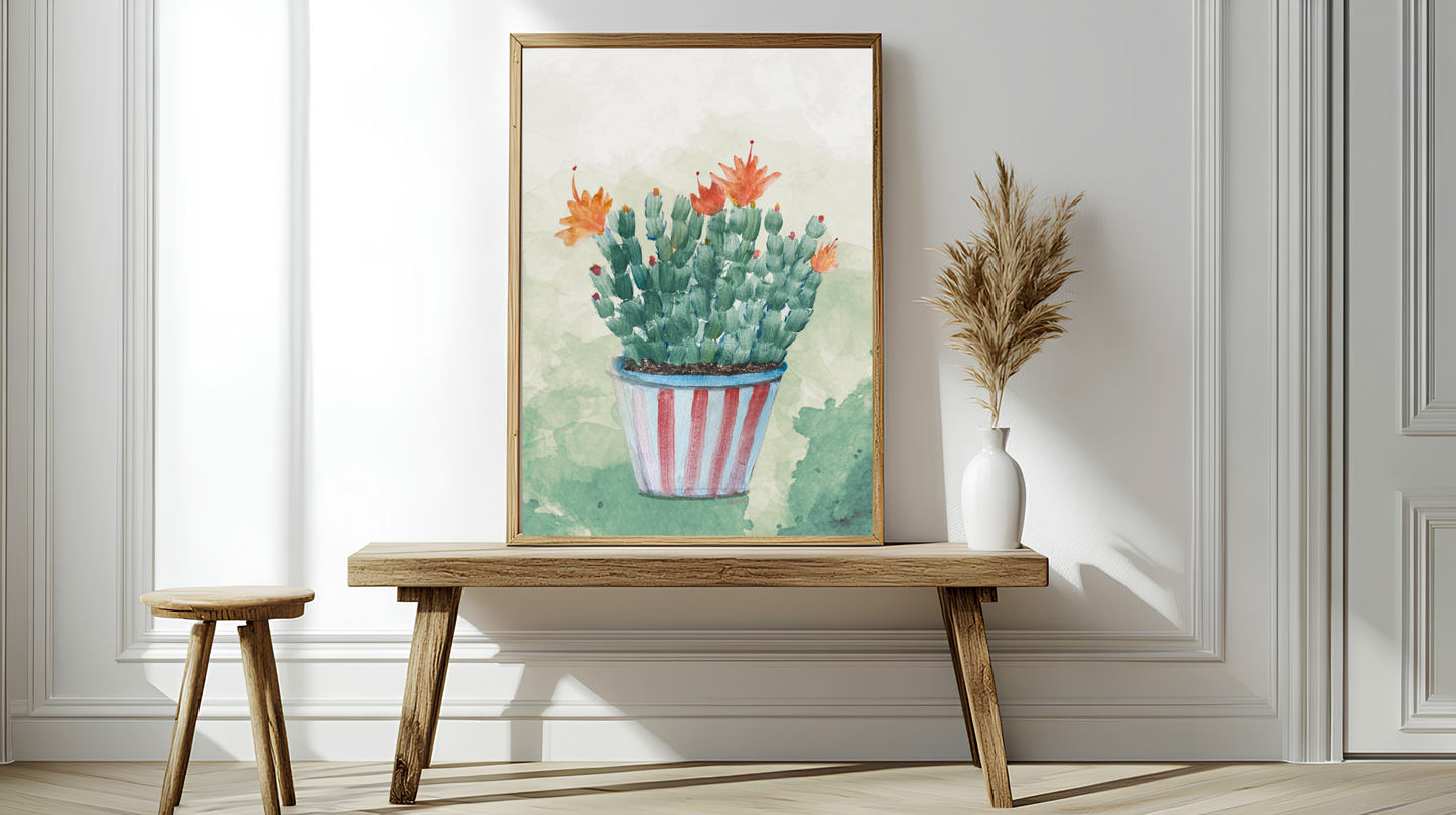 Framed artwork of a cactus on a wooden bench against a white wall.