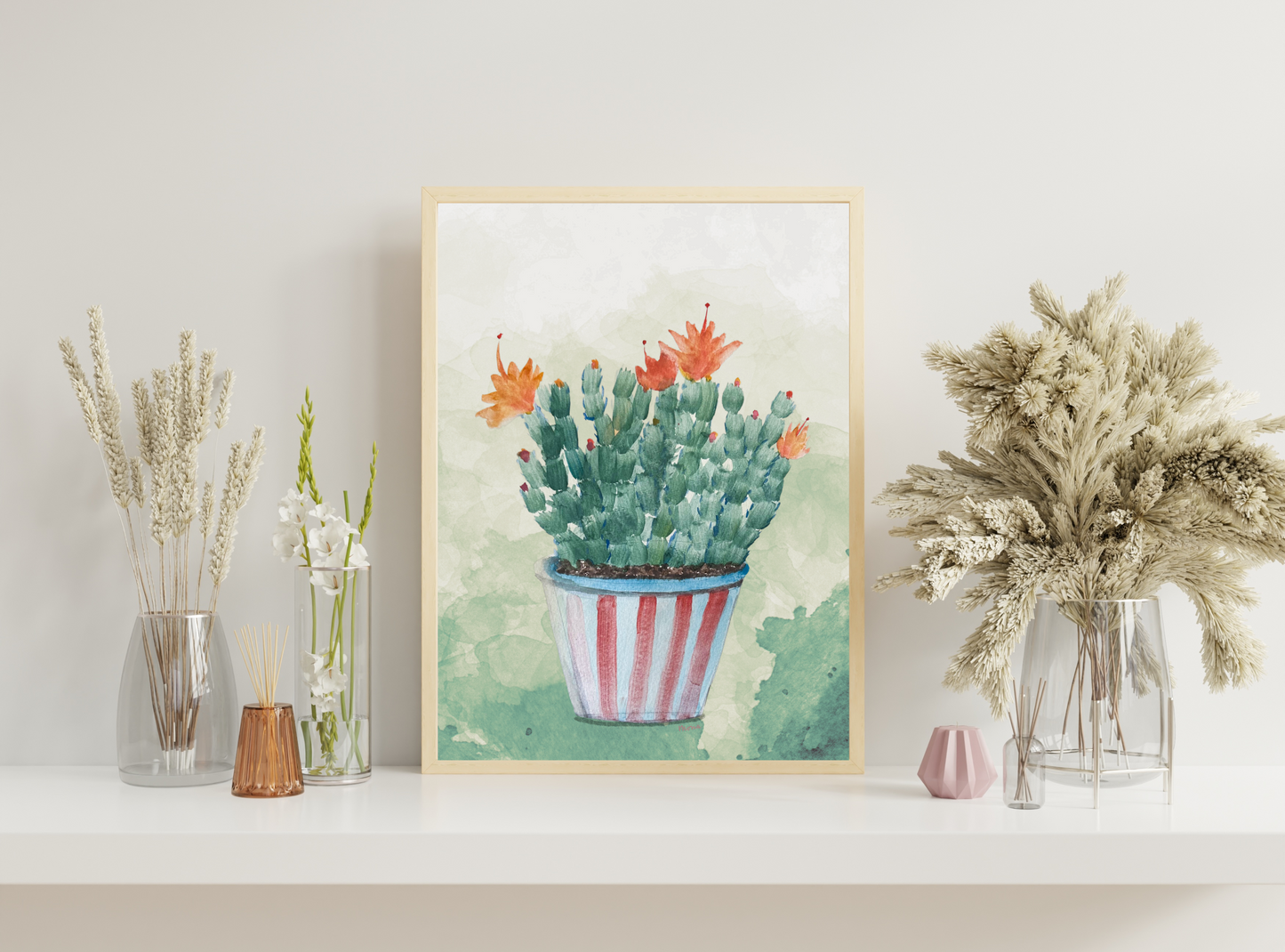 Framed artwork of a Christmas cactus with flowers on a shelf with decorative vases.